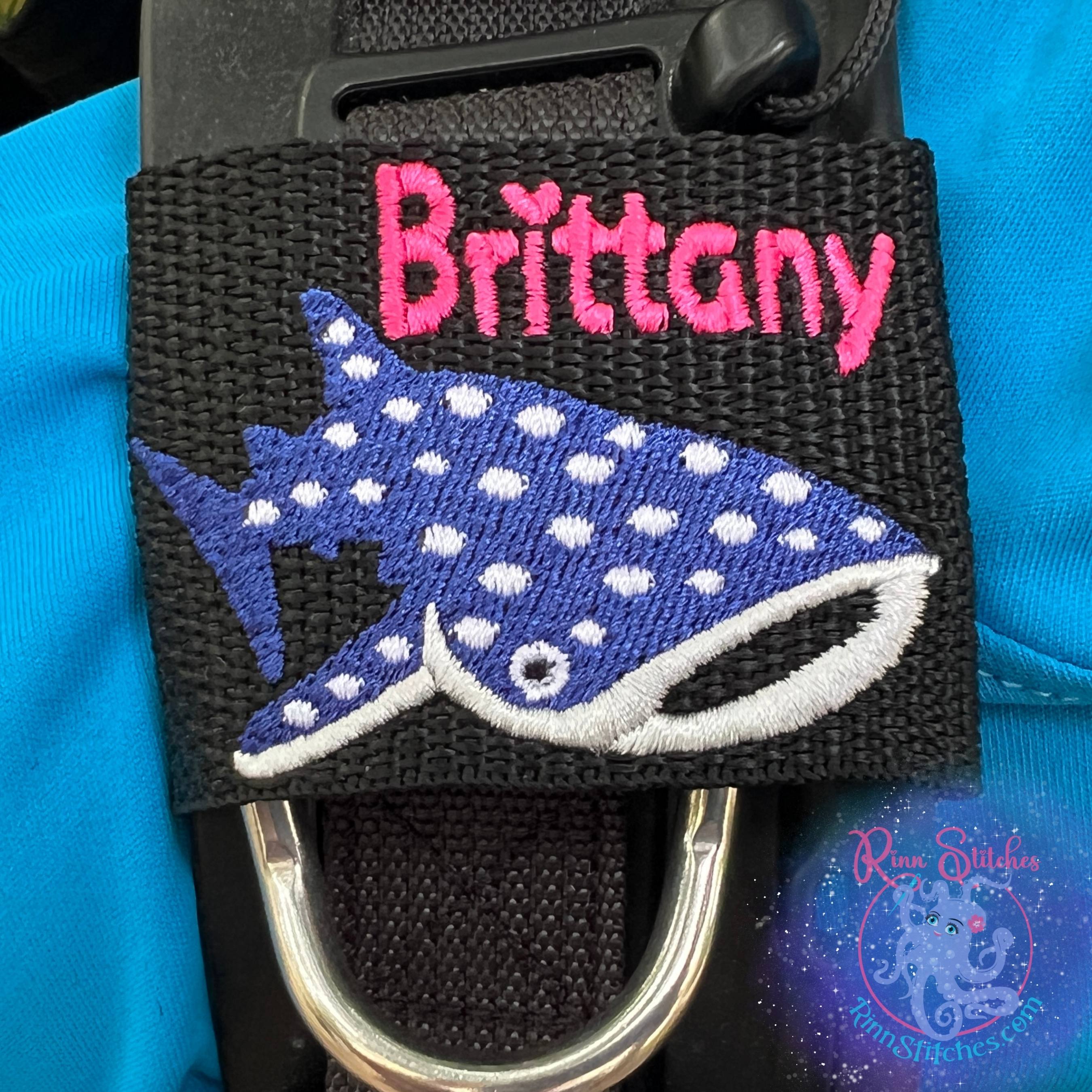 Cute whale shark personalized BCD tag blue abyss white silver cartoonish design custom embroidered name scuba diving accessories - Small Jacket Size Name Brittany in Neon Pink and Haliimaile Font - Made by Rinn Stitches in Maui, Hawaii