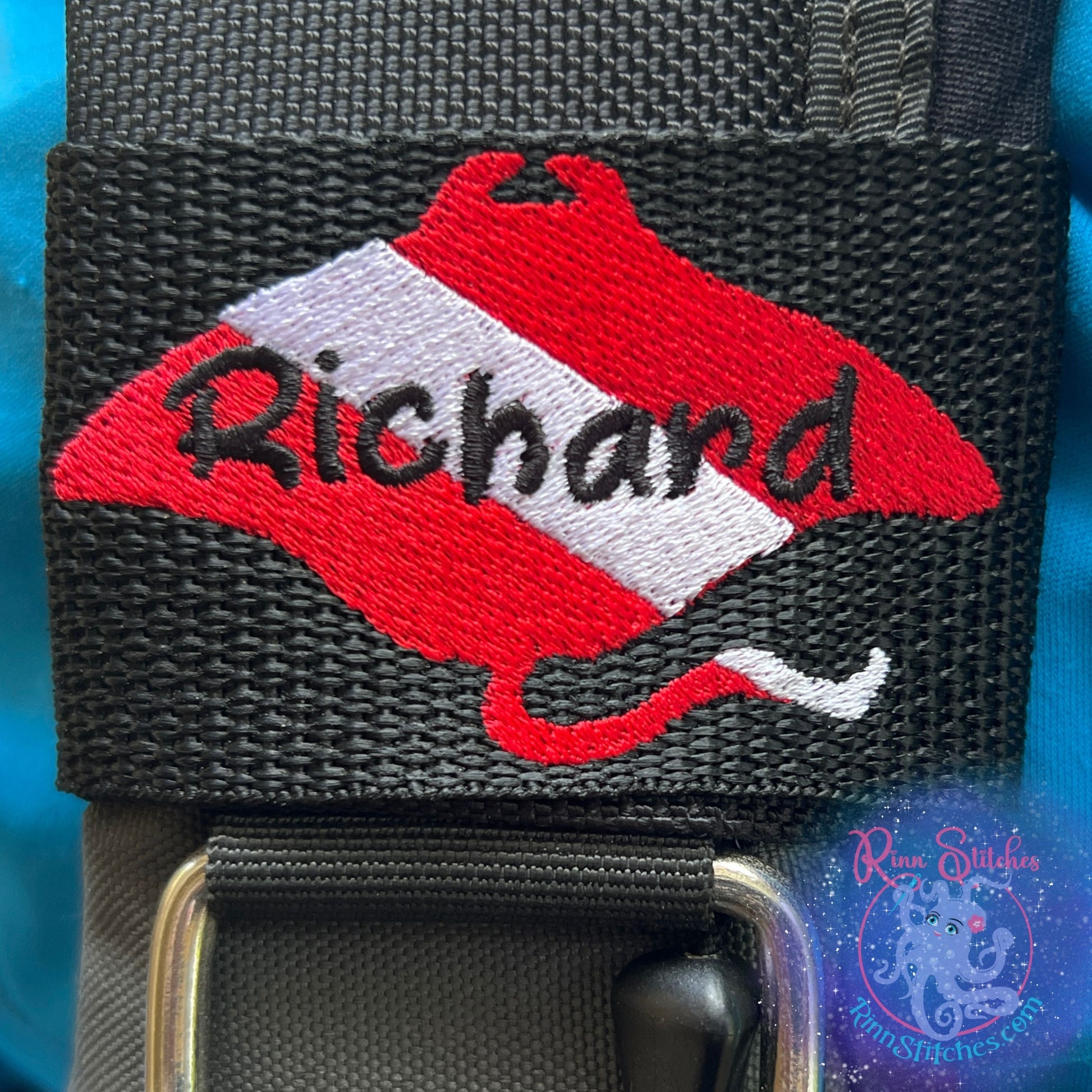 Dive flag manta ray personalized BCD tag red and white manta silhouette black name Richard embroidered in Sand Castle Font in center scuba diving accessories By Rinn Stitches on Maui, Hawaii