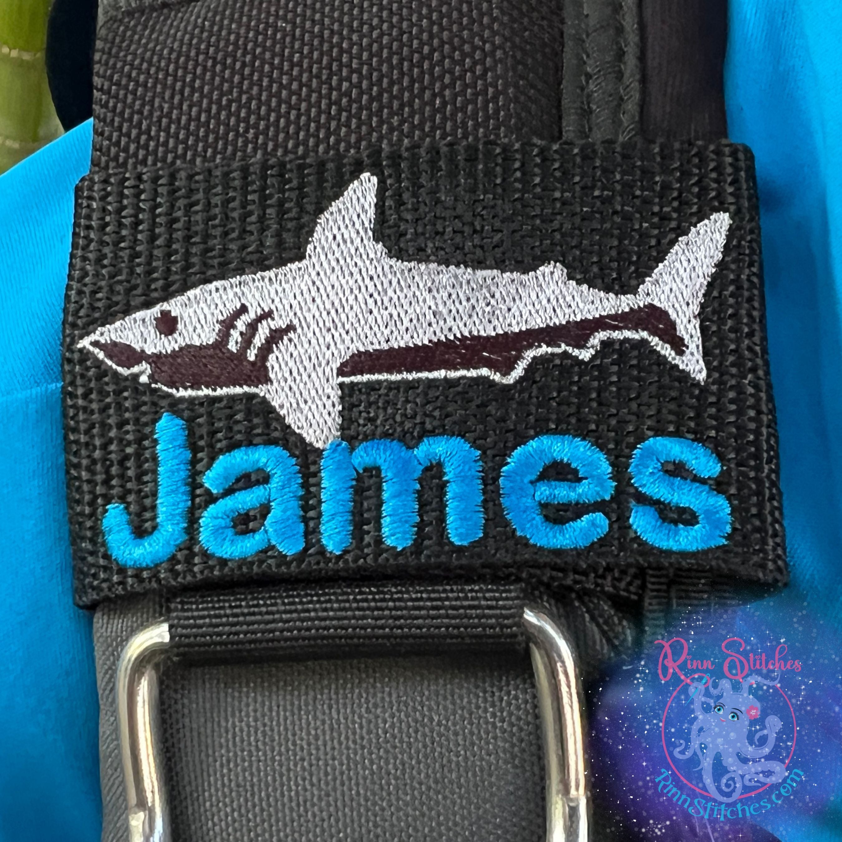 Shark personalized BCD tag silhouette design shark fin black thread colors custom embroidered name below scuba diving accessories By Rinn Stitches on Maui, Hawaii