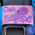 Tako (Octopus) | Personalized & Customizable Scuba Diver BCD Identification Tag | Made on Maui | Scuba Diver Gift | Rinn Stitches Creative & Unique Embroidery - Pink Webbing - Purple Tako with the name Deb in Purple Thread and Haliimaile Font