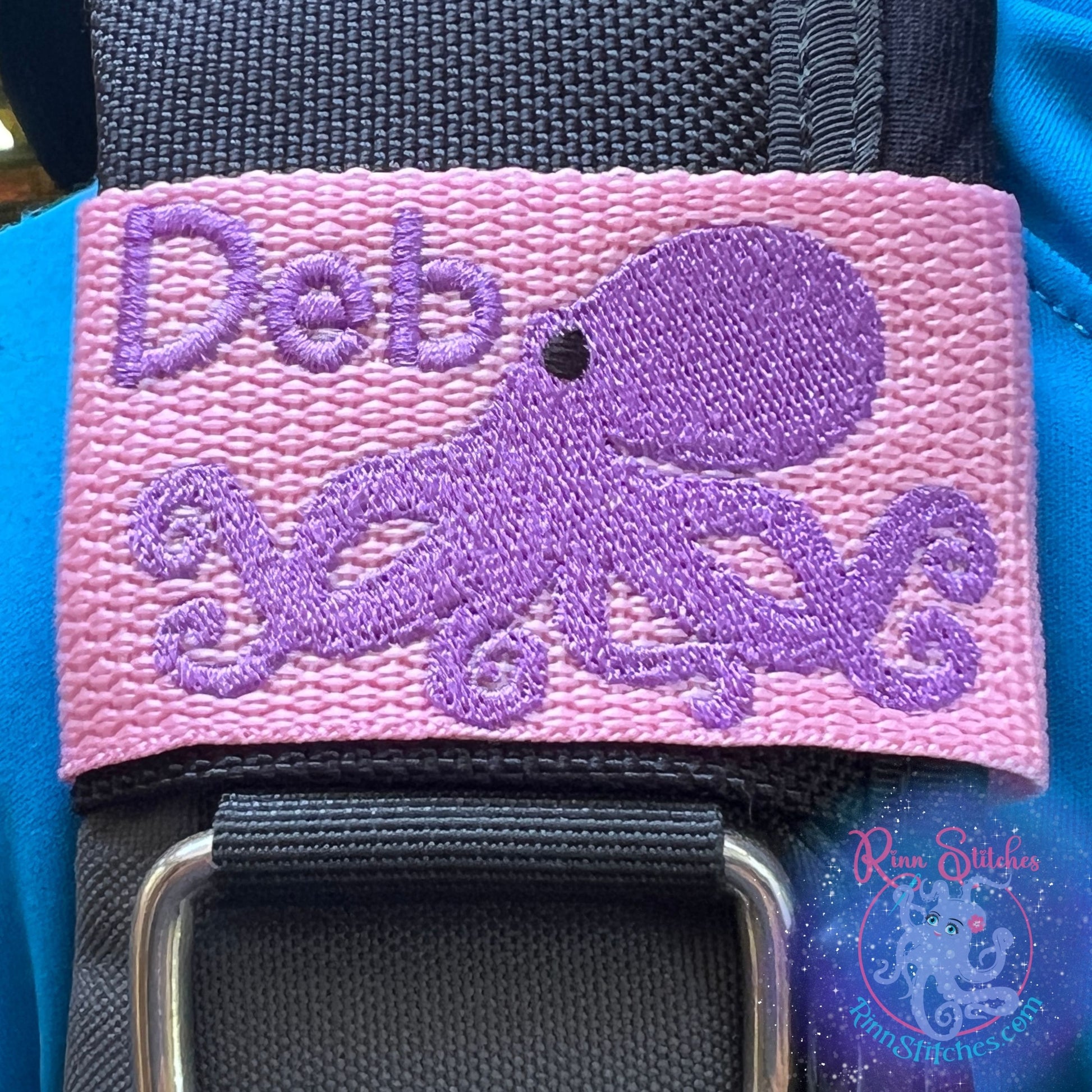 Tako (Octopus) | Personalized & Customizable Scuba Diver BCD Identification Tag | Made on Maui | Scuba Diver Gift | Rinn Stitches Creative & Unique Embroidery - Pink Webbing - Purple Tako with the name Deb in Purple Thread and Haliimaile Font