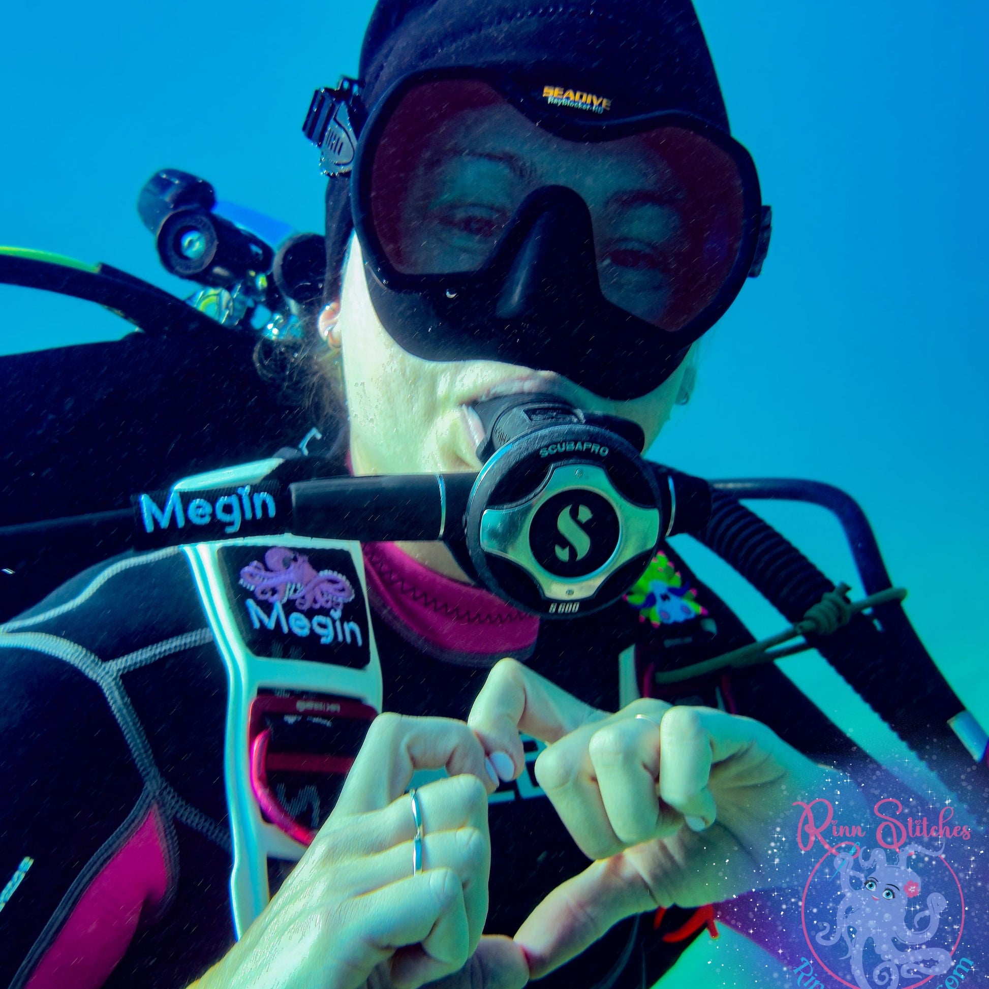 Scuba Diving Regulator Tag featuring the name Megin on a Scuba Diver under water. Made by Rinn Stitches on Maui, Hawaii