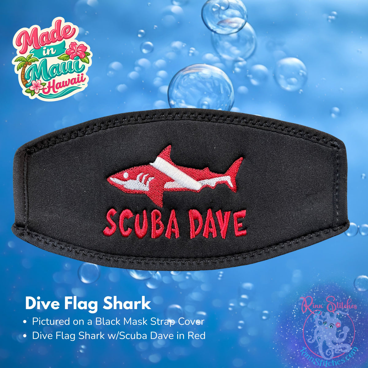 A black neoprene mask strap cover with black piping and an embroidered Dive Flag Shark with Scuba Dave in red. 