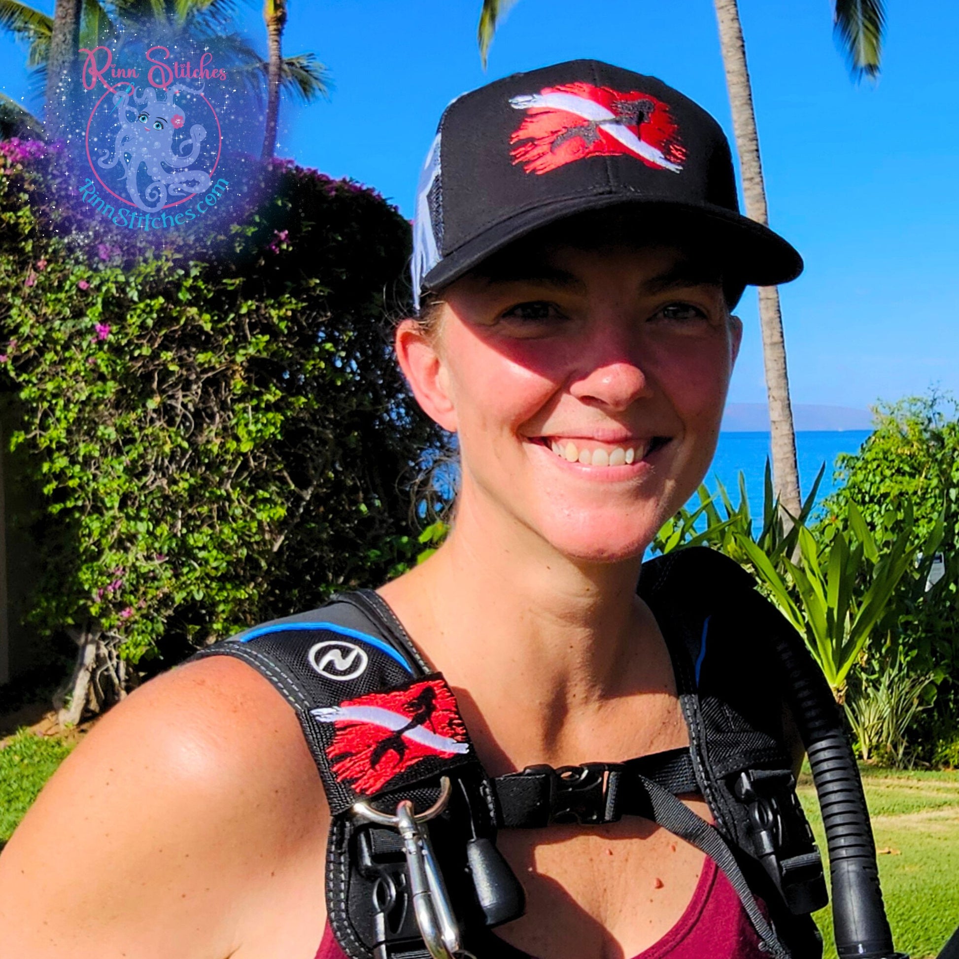 Embroidered BCD Tag & matching embroidered cap featuring and red and white tattered dive flag with a black majestic mermaid silhouette in the middle of the flag. Made by Rinn Stitches in Maui, Hawaii