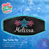 A black neoprene mask strap cover with aqua piping and an embroidered Sea Turtle Tiki with Melissa in White.