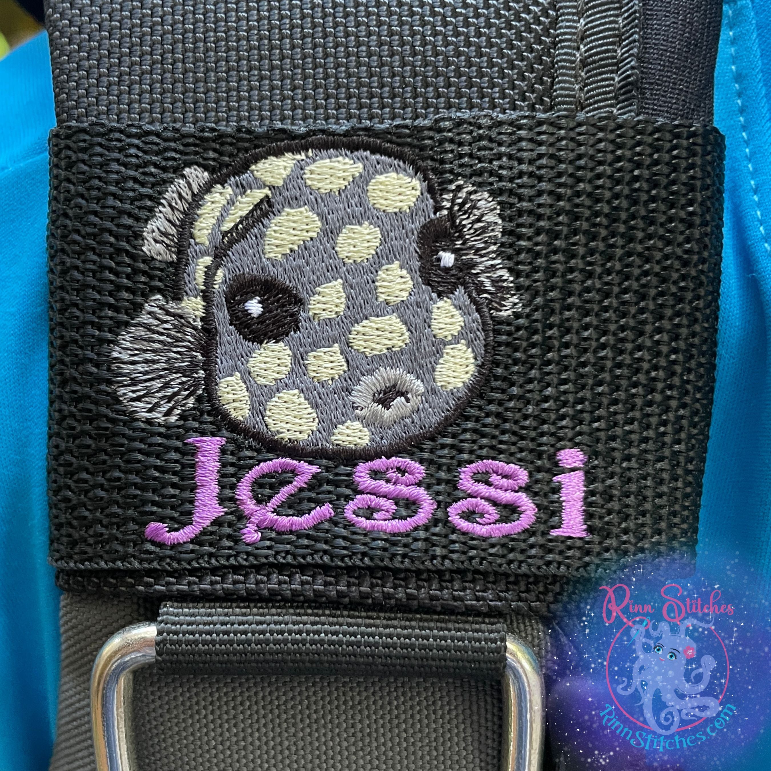 Embroidered juvenile trunkfish design in dark gray with light yellow spots. Featuring the personalization Jessi in purple thread below the cute little fishy. Made by Rinn Stitches in Maui, Hawaii