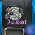 Embroidered juvenile trunkfish design in dark gray with light yellow spots. Featuring the personalization Jessi in purple thread below the cute little fishy. Made by Rinn Stitches in Maui, Hawaii
