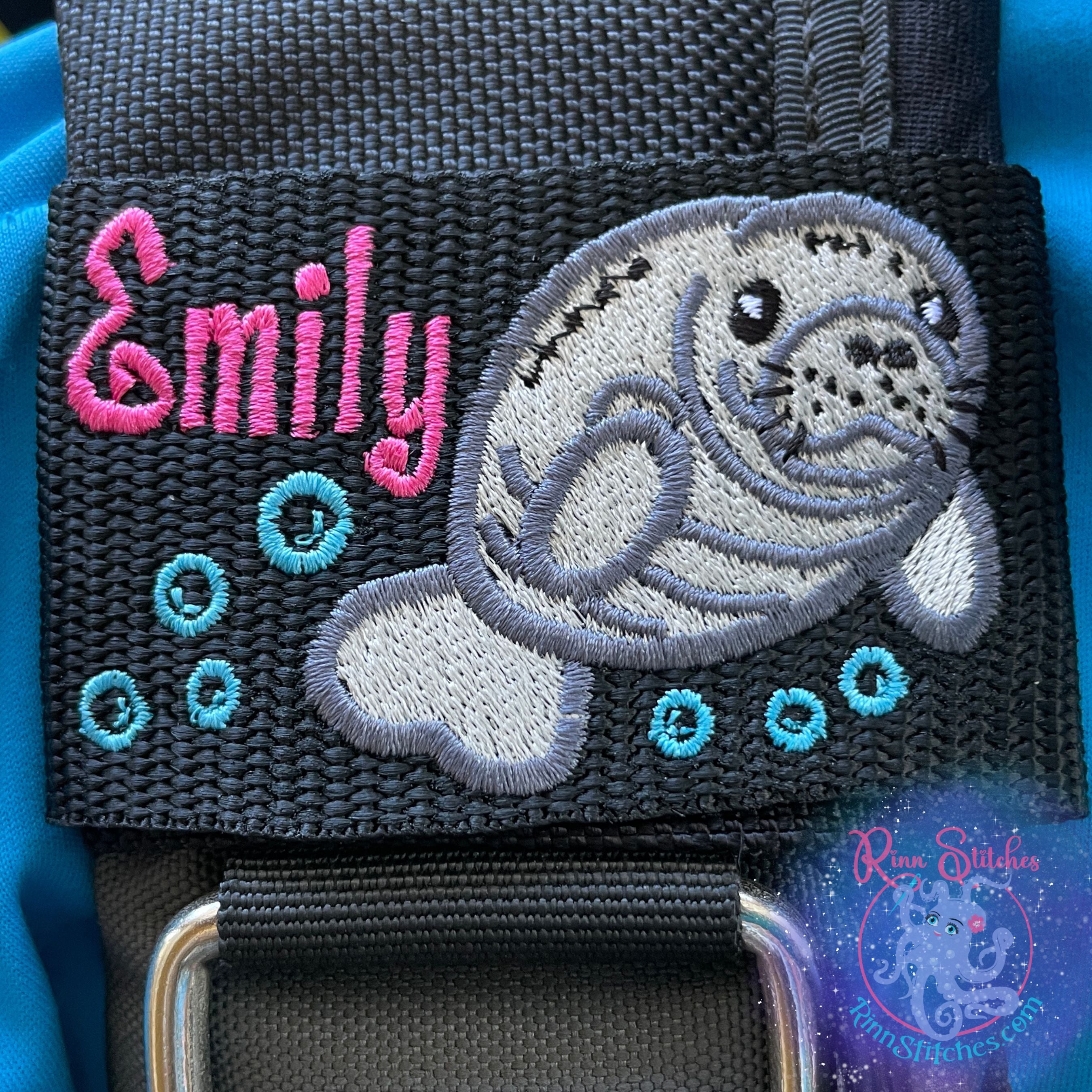 Embroidered BCD Tag featuring an adorable manatee surrounded by ocean blue bubbles and the name Emily in Fuchsia colored thread. Made by Rinn Stitches on Maui, Hawaii