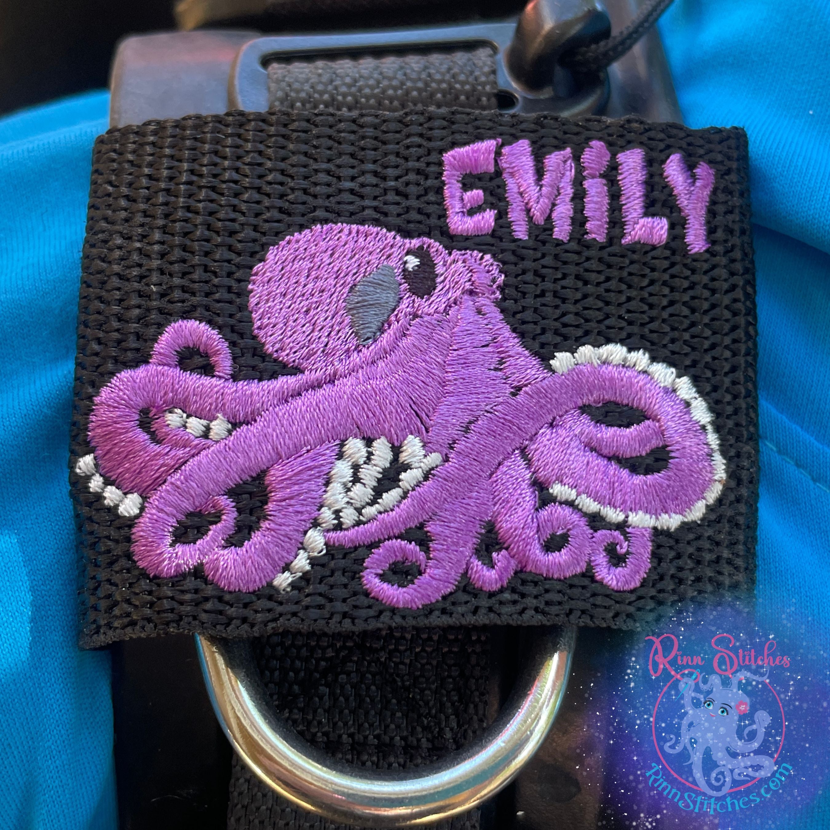 Embroidered Adventure Gear Tag shown on a ScubaPro Hydros BCD featuring and purple and silver octopus design and the name Emily in Purple thread. Made by Rinn Stitches in Maui, Hawaii